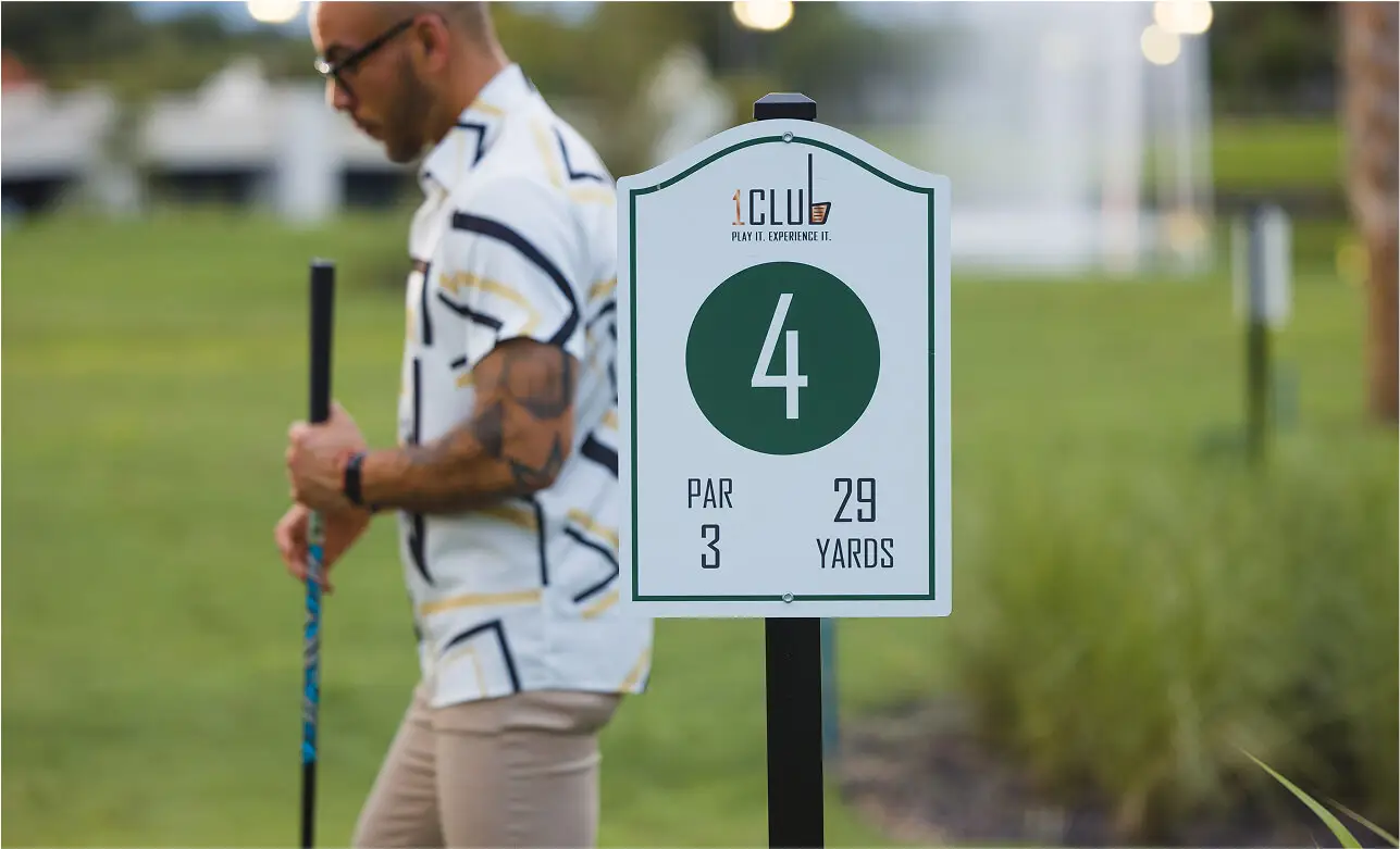 Man with tattooed arms playing park golf at 1Club Plus, located at The Great Gorge in Vernon, NJ