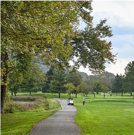 Lush green landscape at The Great Gorge in Vernon, NJ, showcasing rolling hills and vibrant greenery under clear skies.