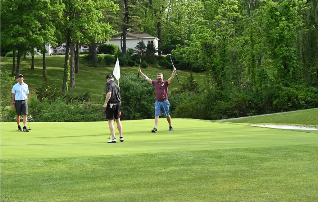 Two men participating in a golf league at The Great Gorge in Vernon, NJ, focused on their game and enjoying the competitive atmosphere.
