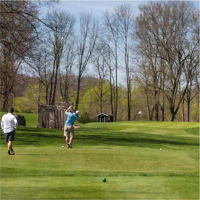 Players enjoying a round of golf on the Rail Course at The Great Gorge in Vernon, NJ, with scenic fairways and rugged terrain in the background.