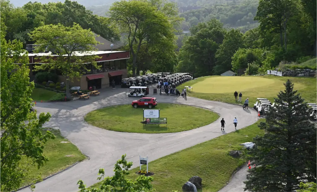 Rows of golf carts neatly lined up at The Great Gorge in Vernon, NJ, ready for use by golfers heading out onto the course, with scenic surroundings in the background.