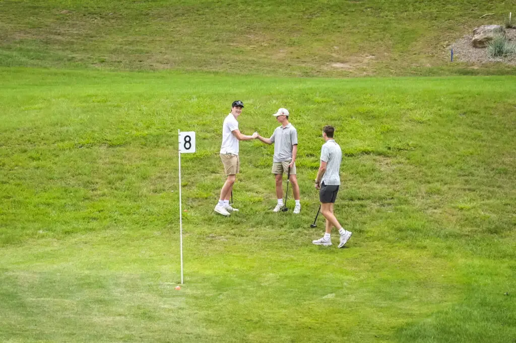 people playing golf in the open