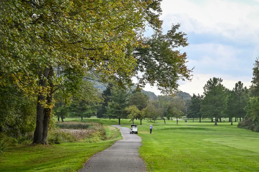 Wide view of Great Gorge Golf Club’s course and natural landscape with colorful fall trees and mountain backdrop.