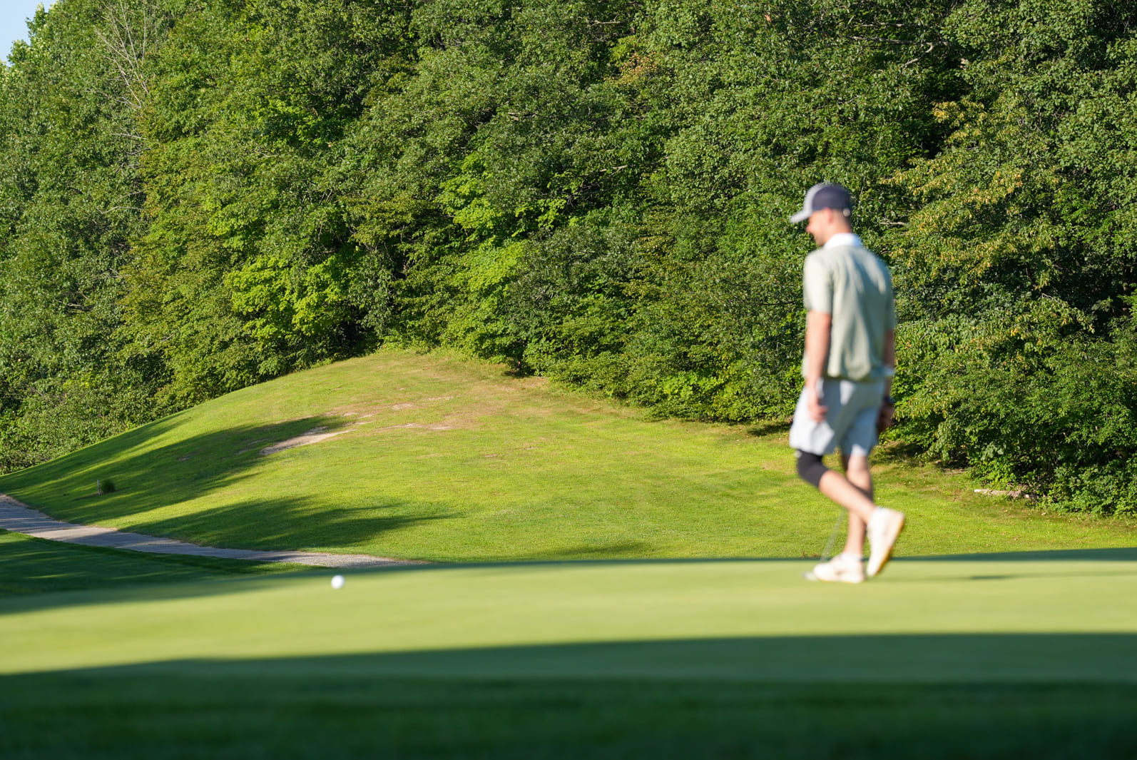 man preparing to hit the ball at a golf game at Great Gorge, on a spring day