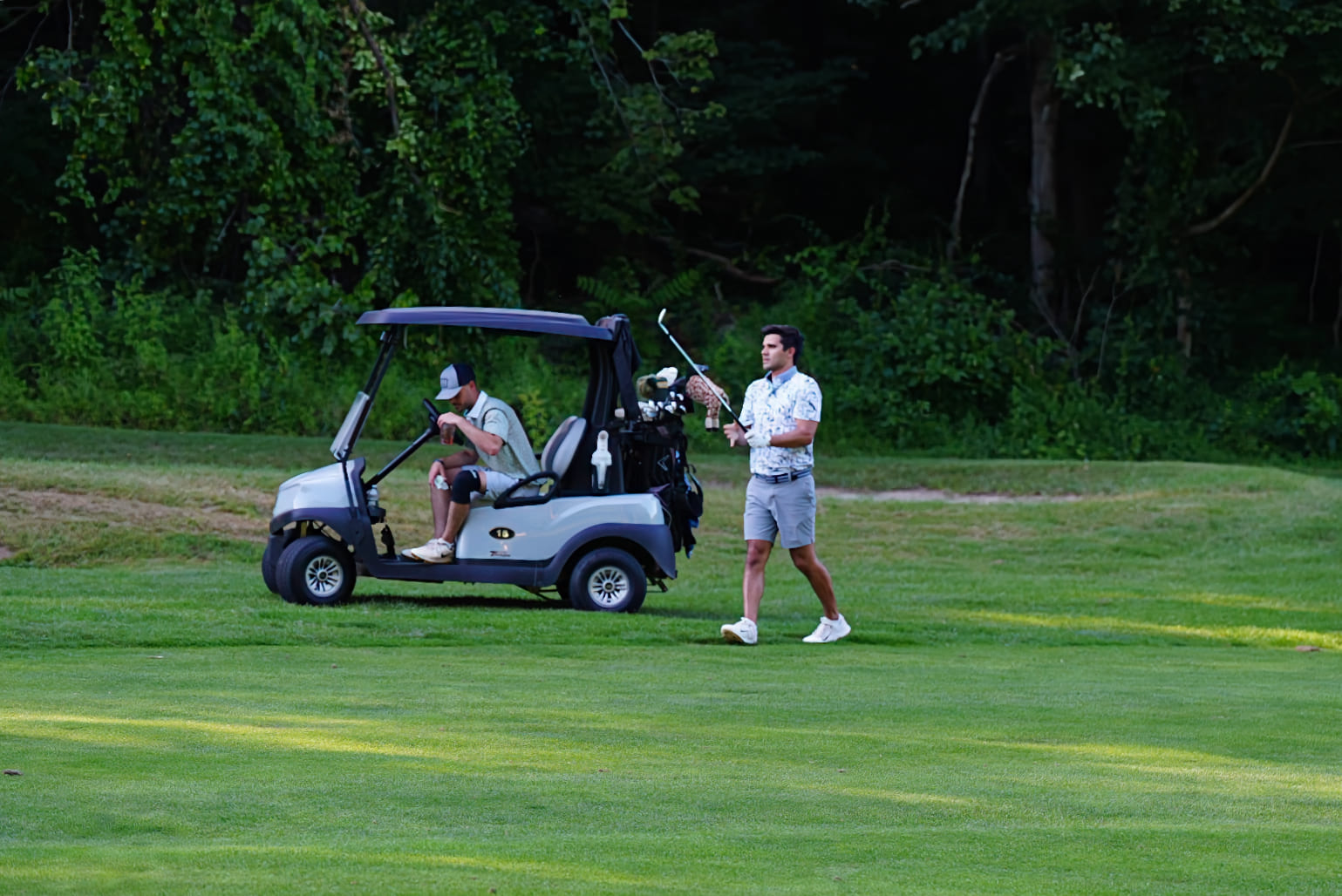 man at Great Gorge Golf club, preparing to play, a golf cart by his side